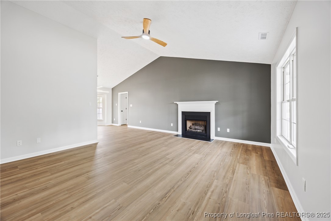 122 Tanner Loop Raeford, NC 28376 - Photo 4 of 36 a view of an empty room with wooden floor and a window