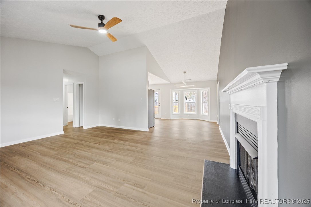 122 Tanner Loop Raeford, NC 28376 - Photo 5 of 36 a view of empty room with fireplace and wooden floor