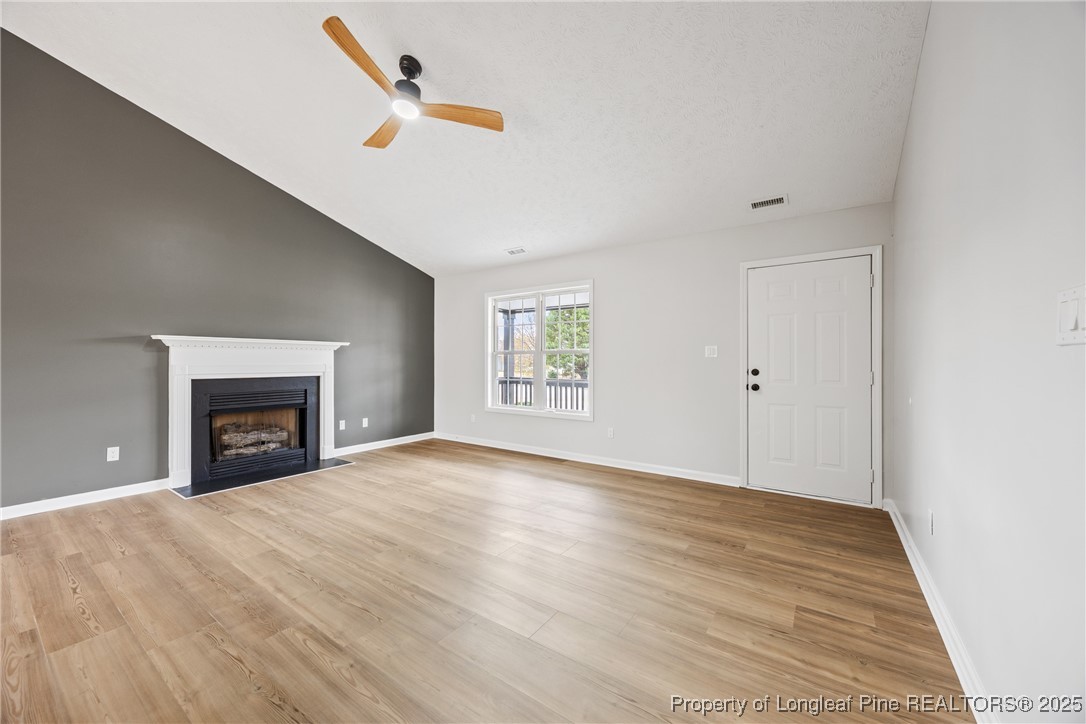 122 Tanner Loop Raeford, NC 28376 - Photo 7 of 36 a view of an empty room with a fireplace