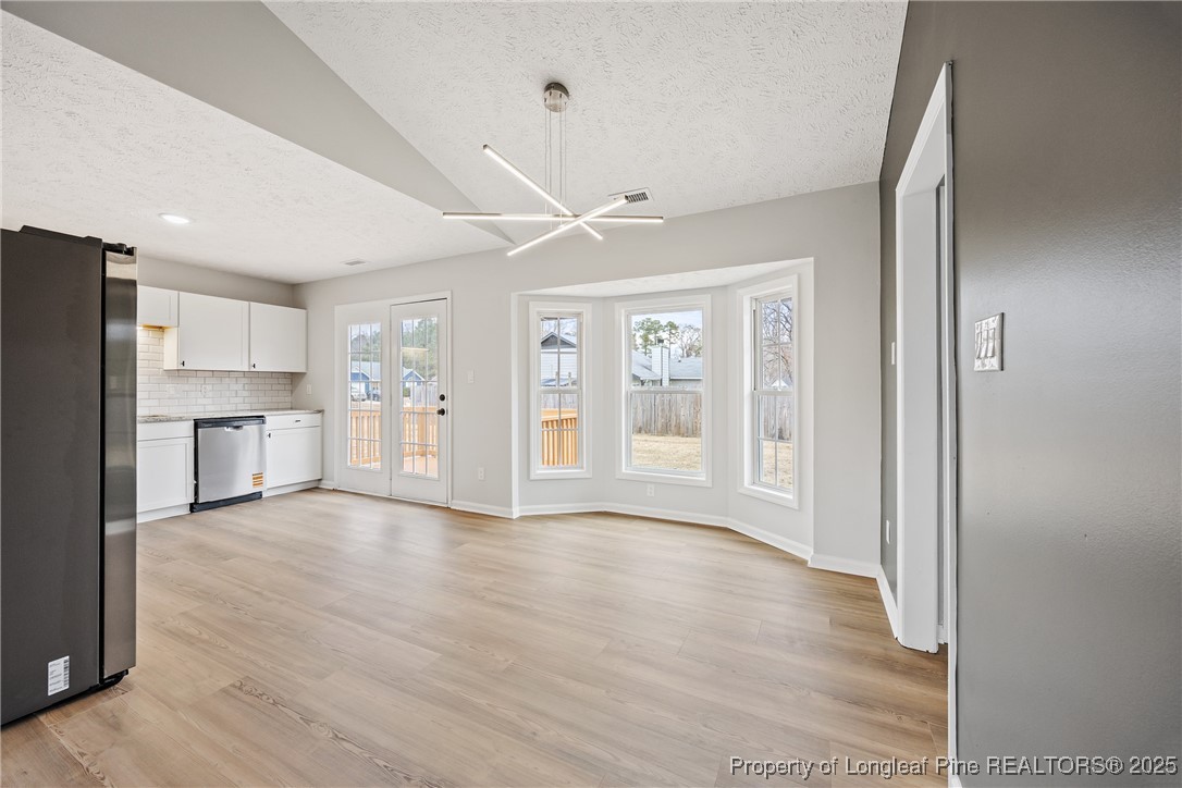 122 Tanner Loop Raeford, NC 28376 - Photo 9 of 36 a view of an empty room with a kitchen