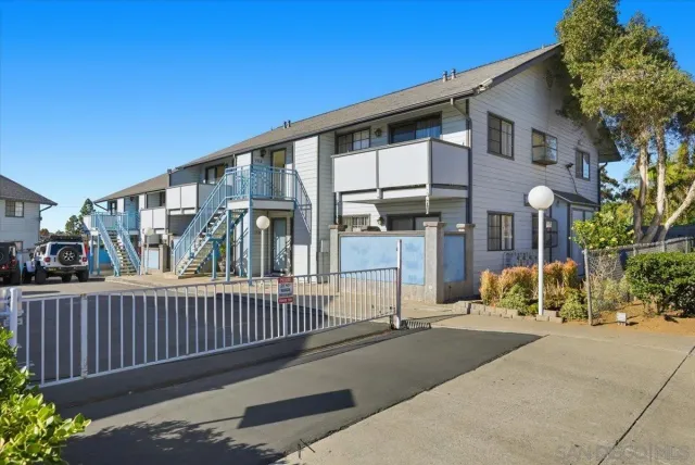 a view of a house with wooden fence