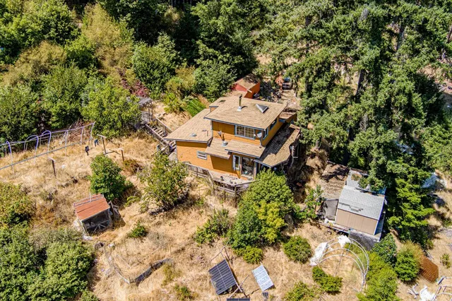 an aerial view of a house with a yard