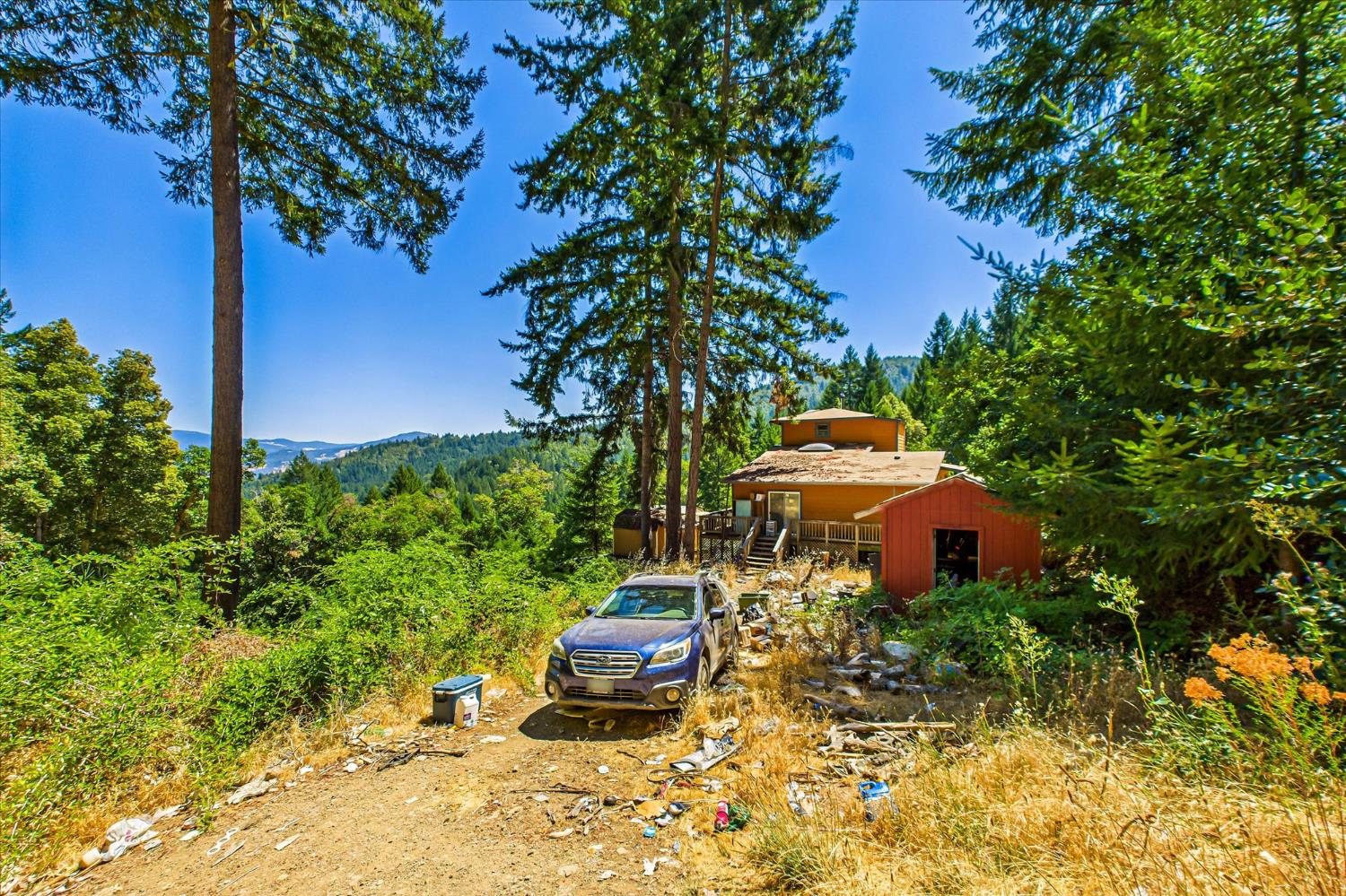 5500 Rancho Sequoia Drive Alderpoint, CA 95511 - Photo 11 of 30 a front view of a house with garden