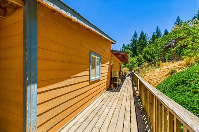 a view of balcony with wooden floor and fence