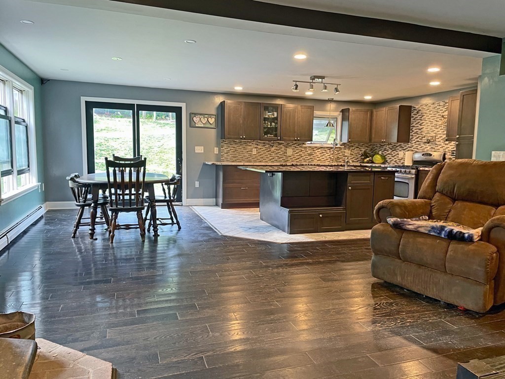241 Thompson Road Colrain, MA 01340 - Photo 15 of 42 a living room with kitchen island furniture and a kitchen view