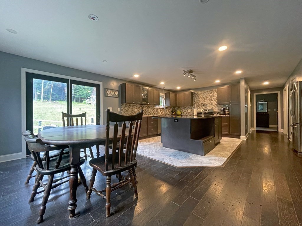 241 Thompson Road Colrain, MA 01340 - Photo 16 of 42 a view of a dining room with furniture and wooden floor