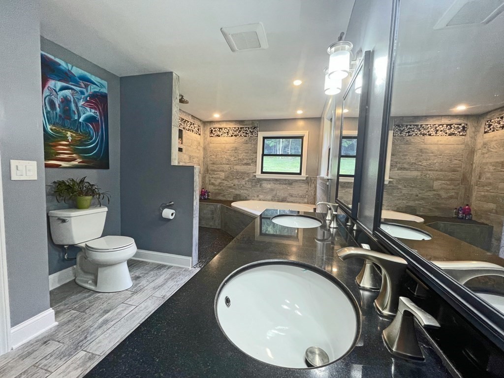 241 Thompson Road Colrain, MA 01340 - Photo 17 of 42 a bathroom with a toilet sink and mirror