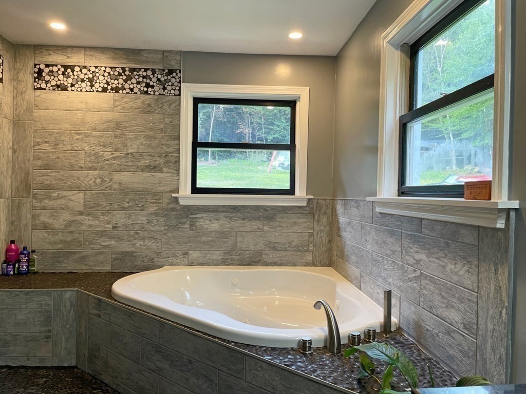 241 Thompson Road Colrain, MA 01340 - Photo 19 of 42 a bathroom with a bathtub and a shower