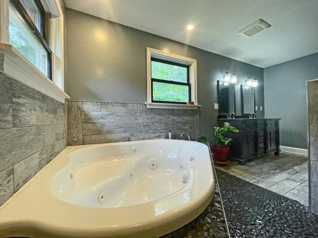 241 Thompson Road Colrain, MA 01340 - Photo 20 of 42 a white bath tub sitting in a bathroom