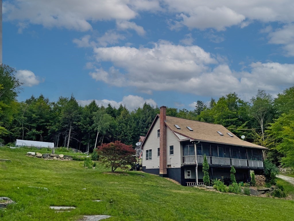 241 Thompson Road Colrain, MA 01340 - Photo 2 of 42 a aerial view of a house next to a big yard and large trees