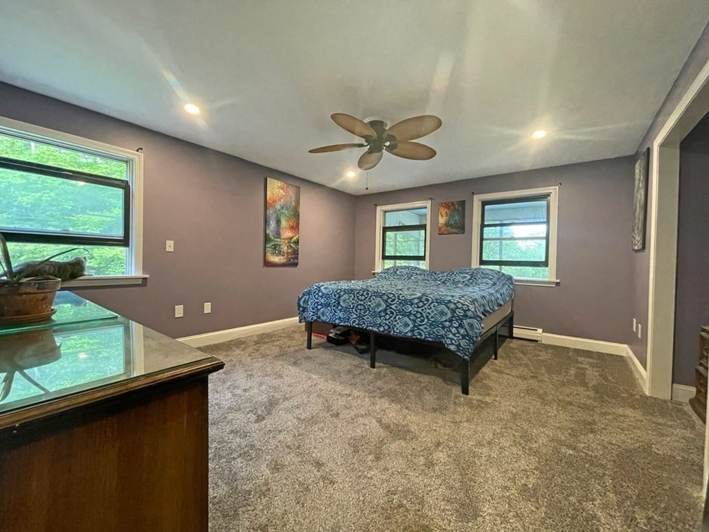 241 Thompson Road Colrain, MA 01340 - Photo 22 of 42 a living room with a bed and a chandelier