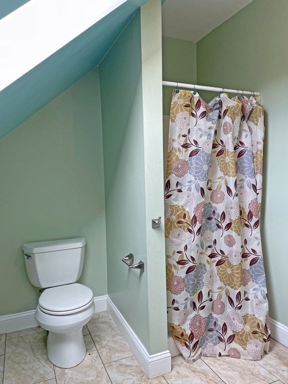 241 Thompson Road Colrain, MA 01340 - Photo 32 of 42 a white toilet sitting next to a shower curtain