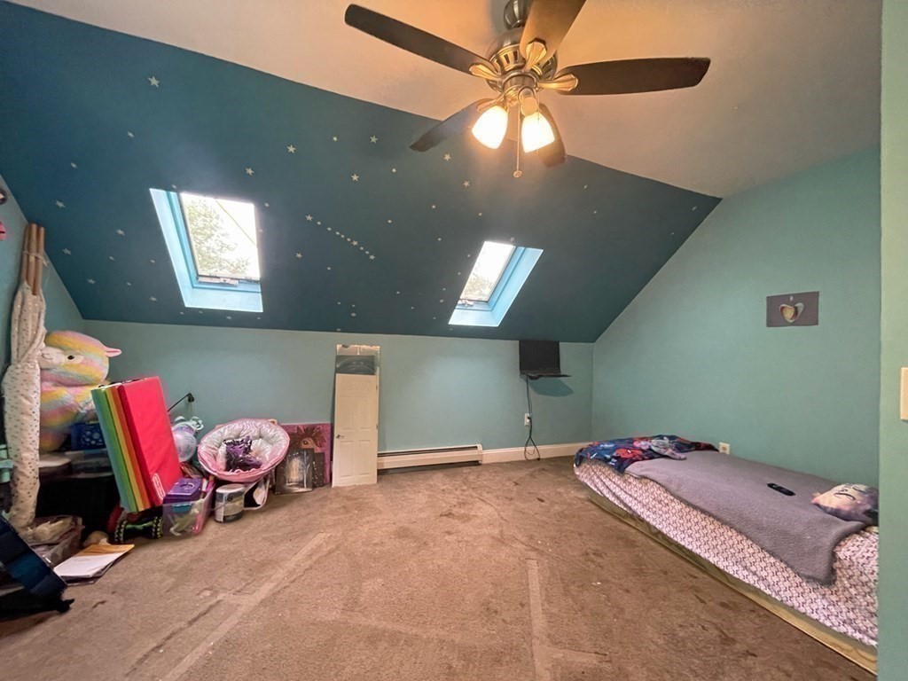 241 Thompson Road Colrain, MA 01340 - Photo 33 of 42 a bedroom with a bed and a chandelier