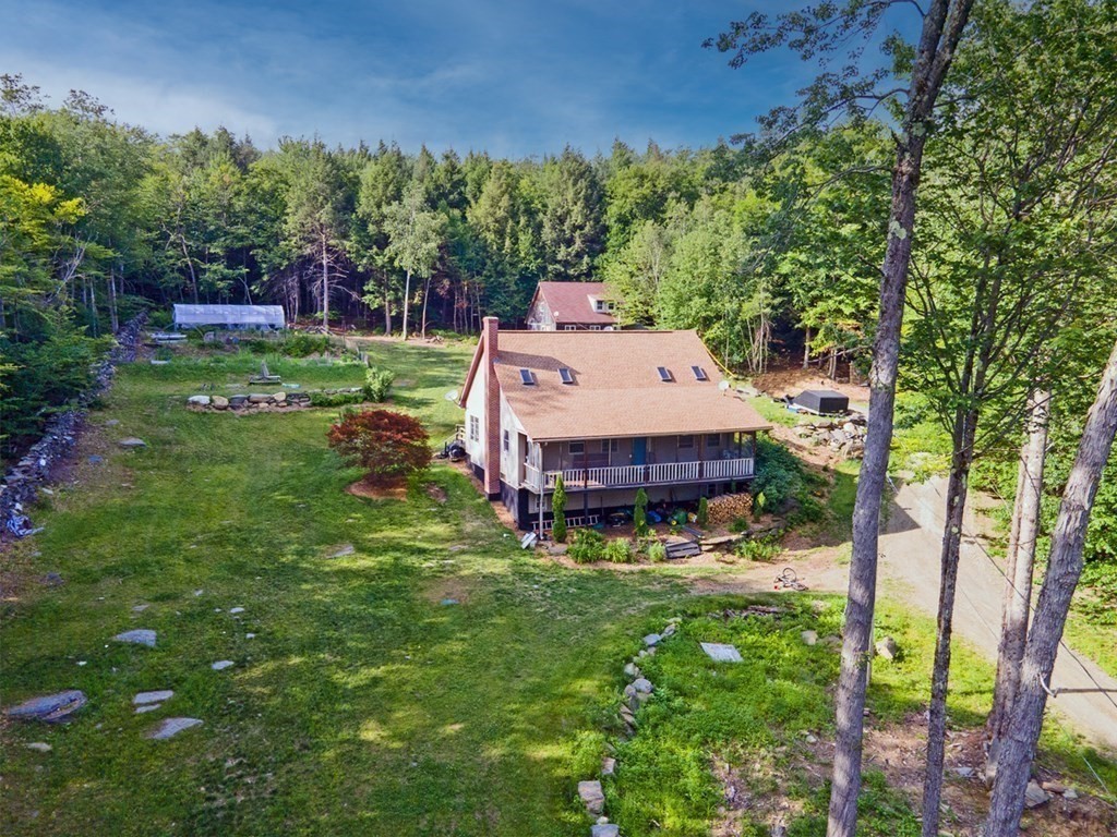 241 Thompson Road Colrain, MA 01340 - Photo 37 of 42 a aerial view of a house with a yard table and chairs