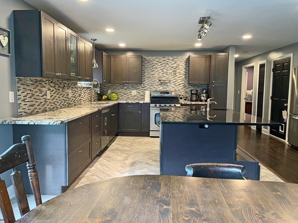 241 Thompson Road Colrain, MA 01340 - Photo 10 of 42 a large kitchen with kitchen island a large counter top and stainless steel appliances
