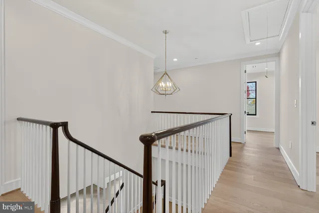 a white bath tub sitting next to a white toilet and vanity