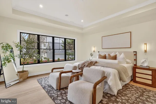 a bedroom with a large bed and a window