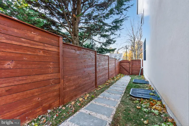 a view of a pathway with a wooden fence