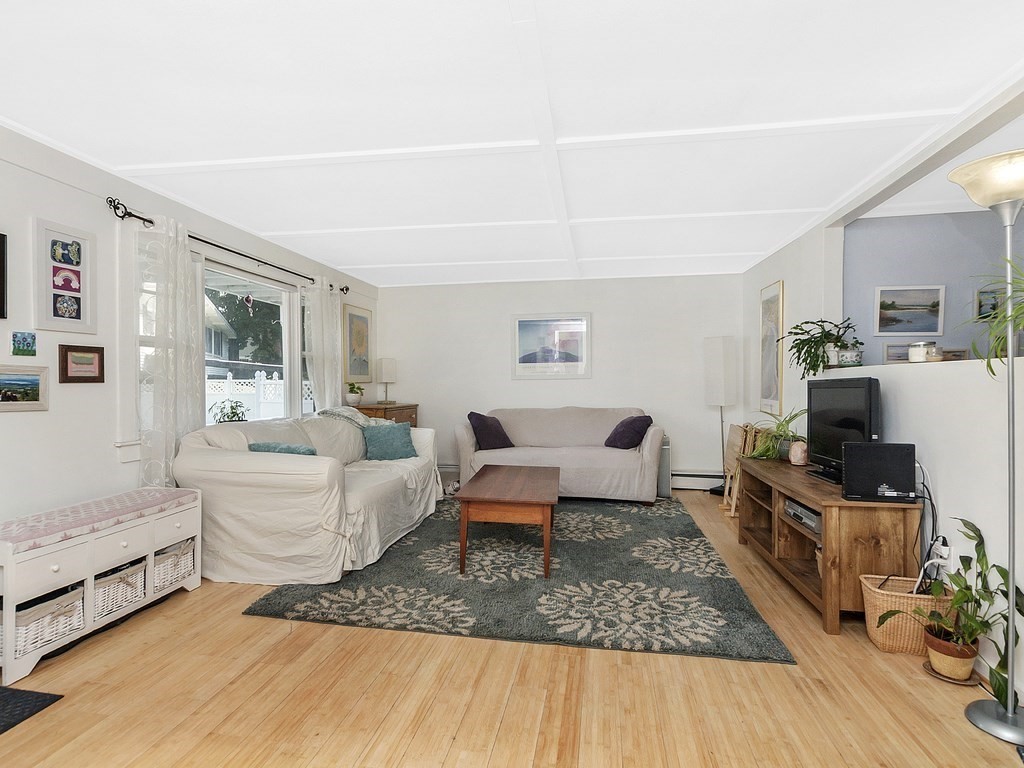 2 Filias, Unit 1 Manchester, MA 01944 - Photo 4 of 11 a living room with furniture and a flat screen tv