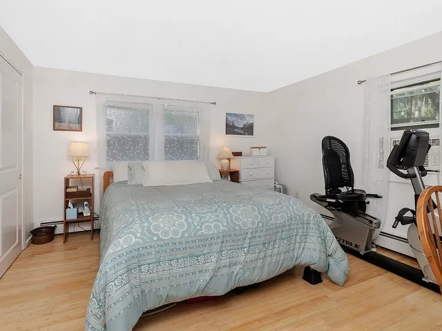 a bedroom with bed and a window