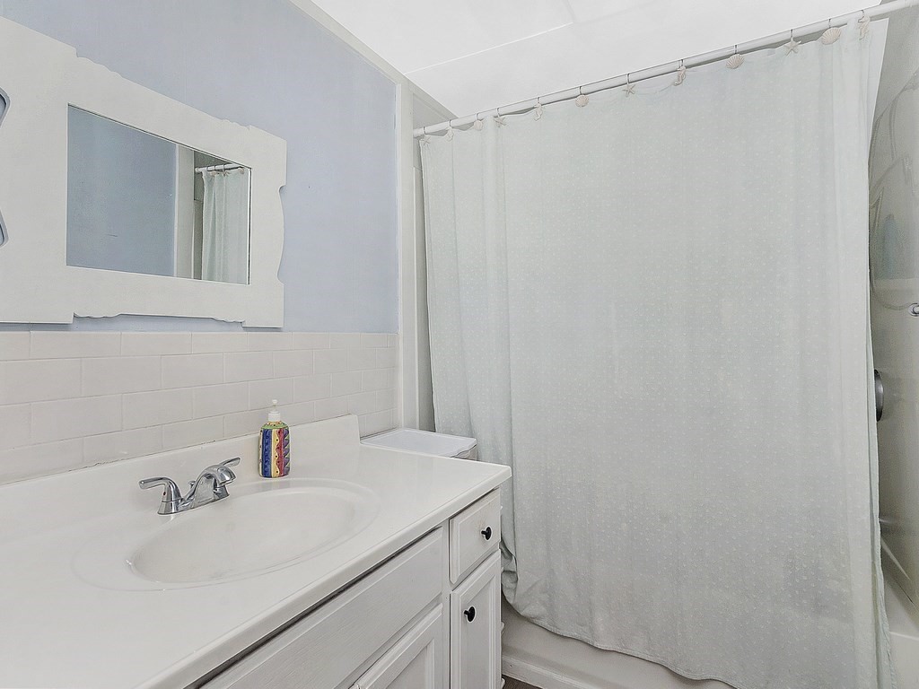 2 Filias, Unit 1 Manchester, MA 01944 - Photo 6 of 11 a bathroom with a sink and a mirror