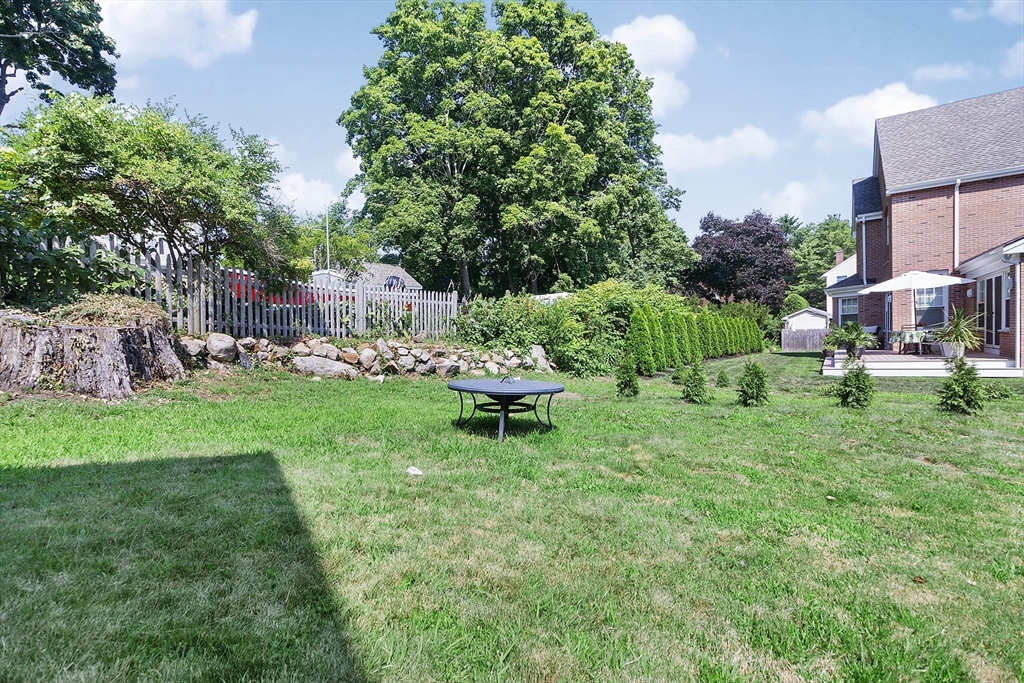 2 Filias, Unit 1 Manchester, MA 01944 - Photo 9 of 11 a view of a chair and table in backyard of the house