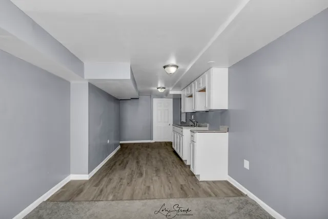 a kitchen with a refrigerator and a stove top oven