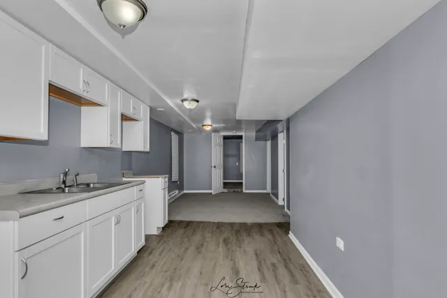a view of a kitchen with a sink cabinets and wooden floor