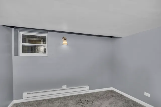 a view of a livingroom with an empty space and a window