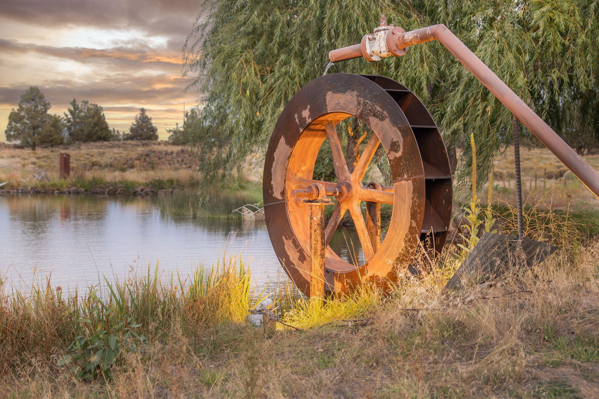 21925 Bear Creek Road Bend, OR 97702 - Photo 96 of 104 Water wheel on the lower pond at night