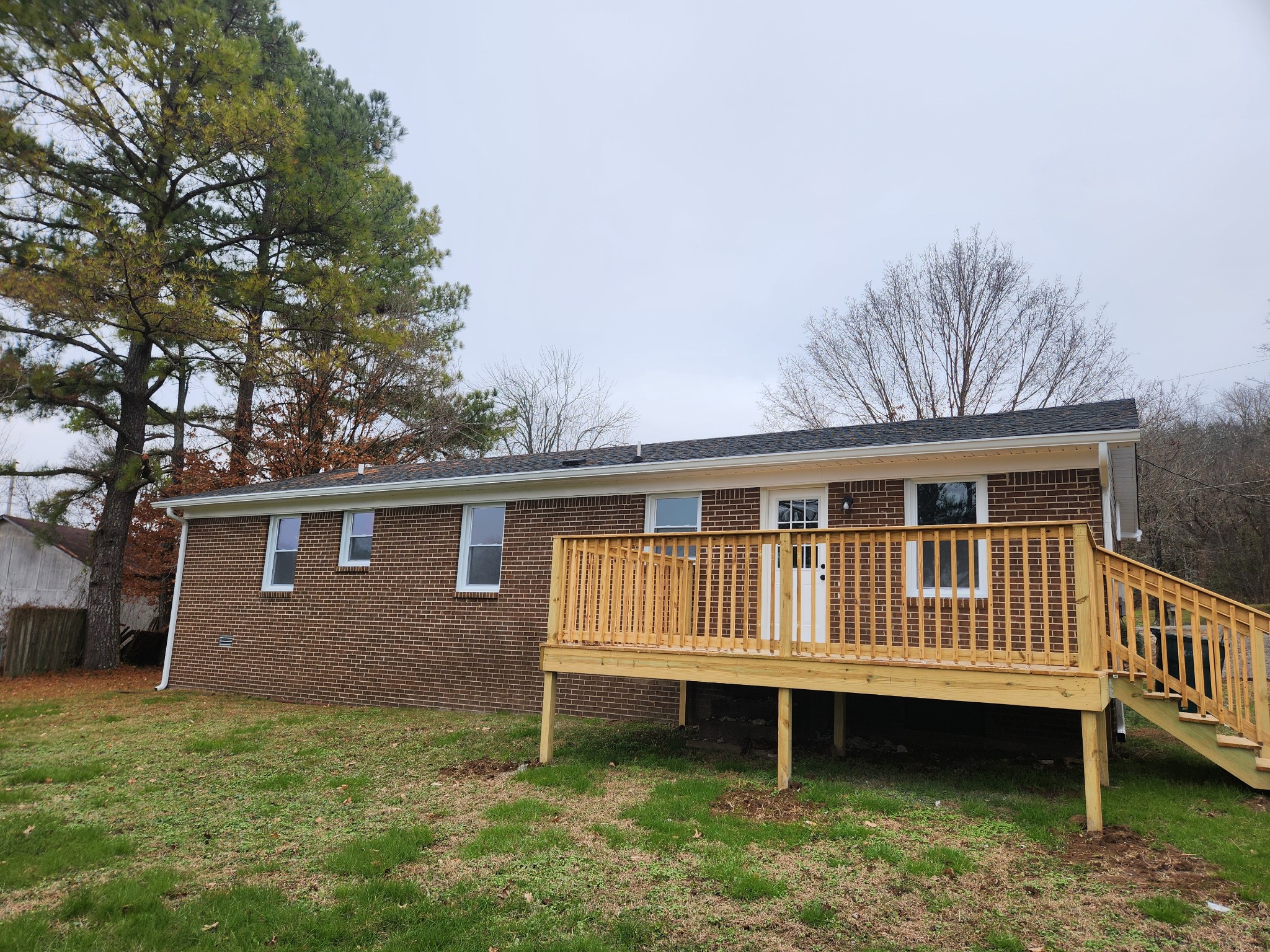 1301 Riley Hill Road Pulaski, TN 38478 - Photo 22 of 23 a view of a house with a wooden deck and a yard
