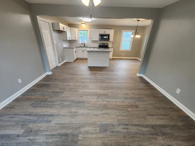 a view of kitchen with sink microwave and stove