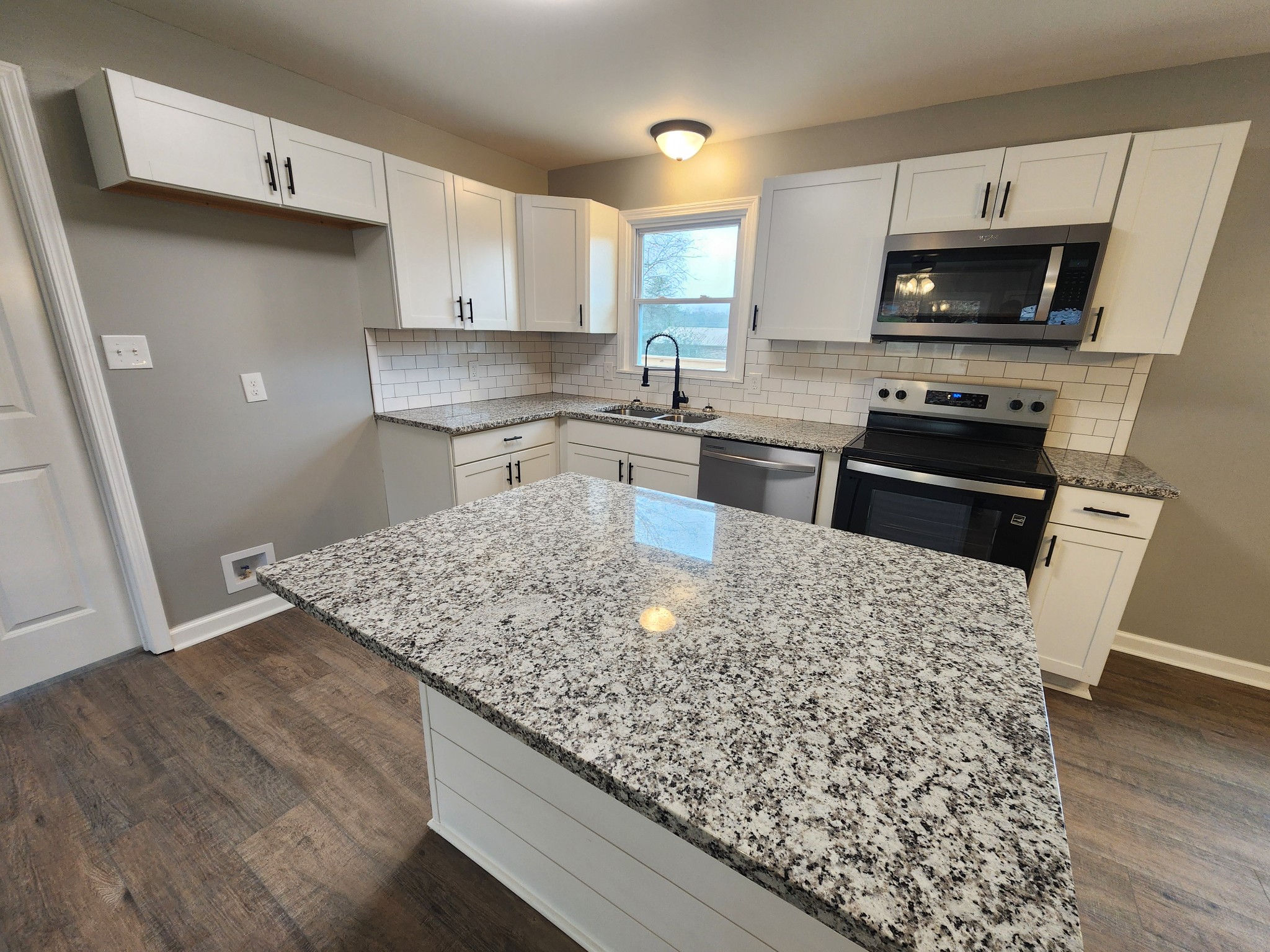 1301 Riley Hill Road Pulaski, TN 38478 - Photo 9 of 23 a kitchen with wooden cabinets and a stove