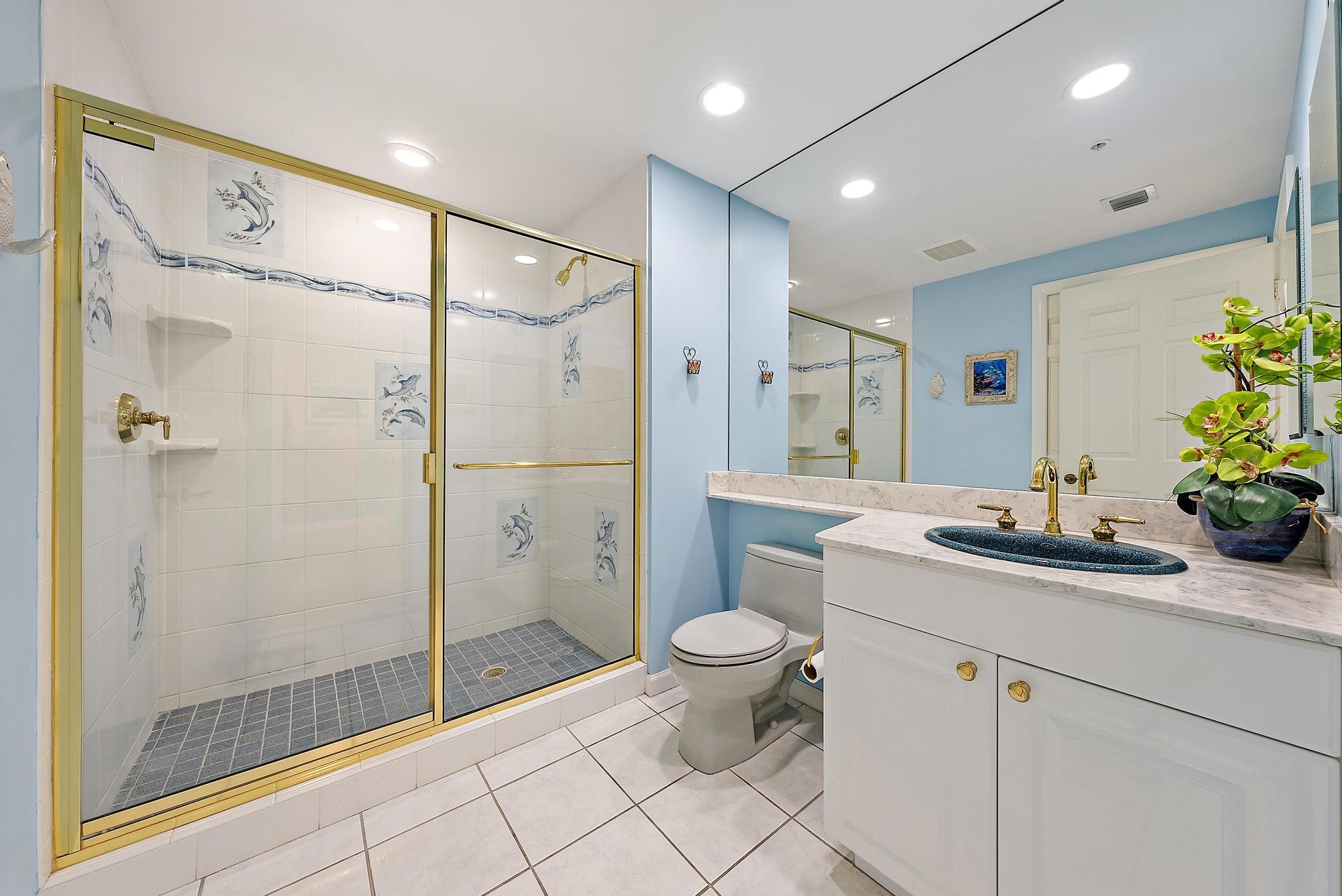 400 Highway 1, Unit 104 Jupiter, FL 33477 - Photo 13 of 35 a bathroom with a granite countertop sink a toilet and shower