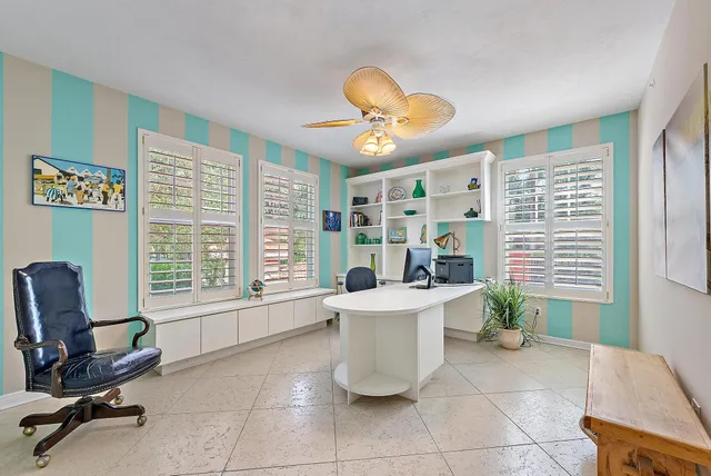 a view of a livingroom with furniture and a large window