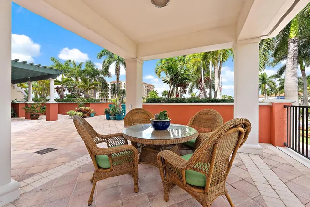 a dining room with furniture and a potted plant