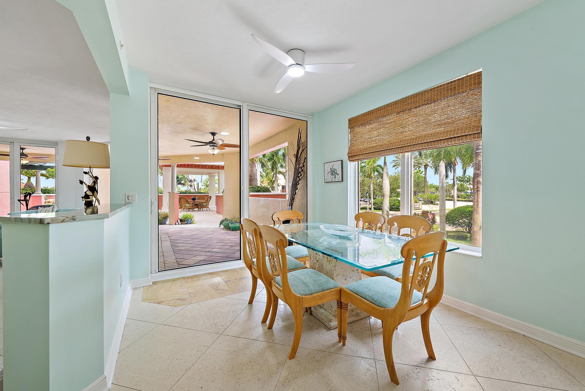 400 Highway 1, Unit 104 Jupiter, FL 33477 - Photo 4 of 35 a dining room with furniture a chandelier and wooden floor