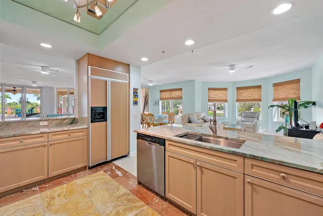 a kitchen with sink and refrigerator