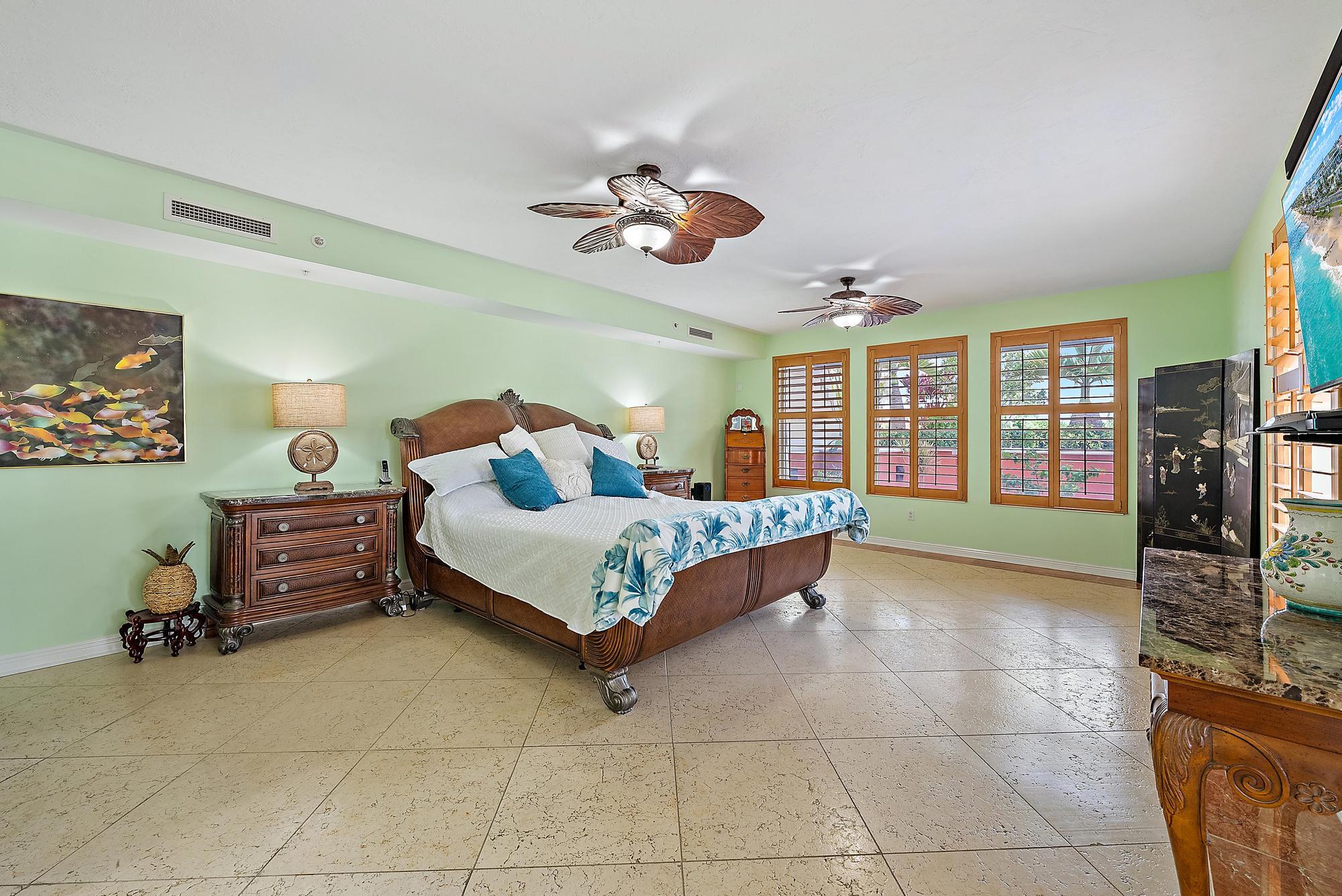 400 Highway 1, Unit 104 Jupiter, FL 33477 - Photo 8 of 35 a bedroom with a bed and cabinets