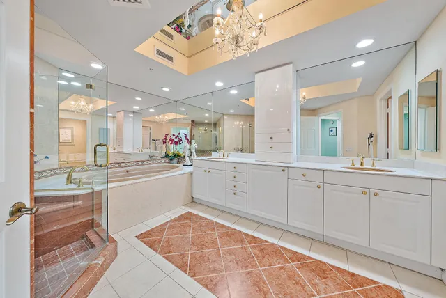 a large bathroom with a large mirror vanity and shower