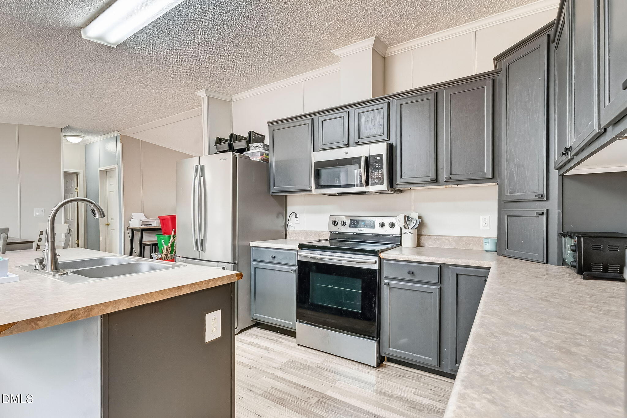 112 Morgan Street Erwin, NC 28339 - Photo 11 of 35 a kitchen with stainless steel appliances a sink stove and cabinets
