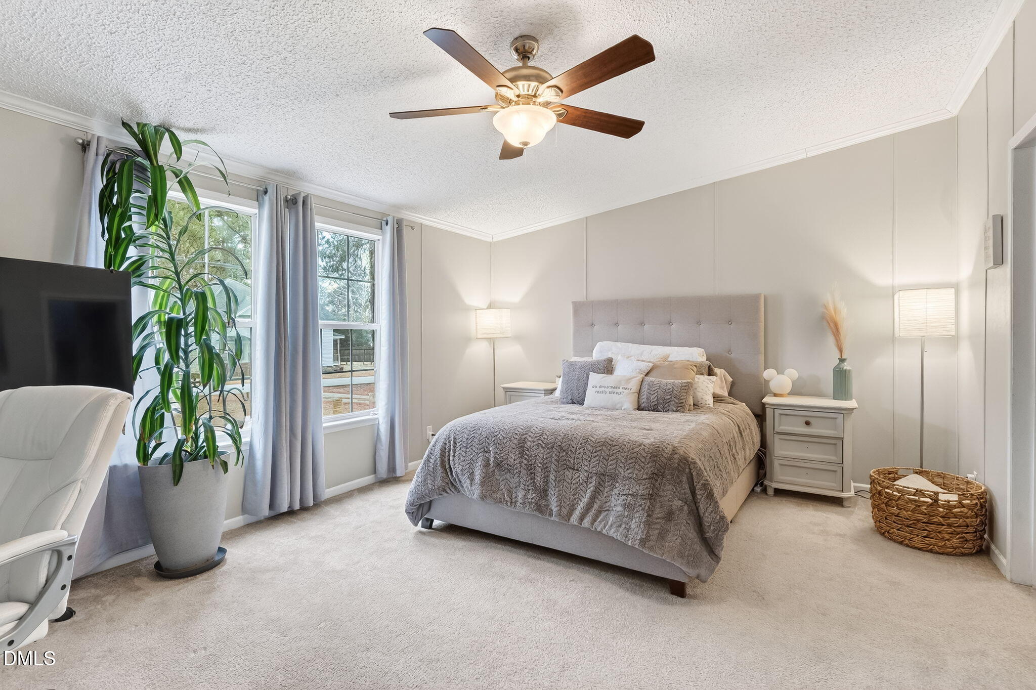 112 Morgan Street Erwin, NC 28339 - Photo 14 of 35 a spacious bedroom with a bed and a potted plant