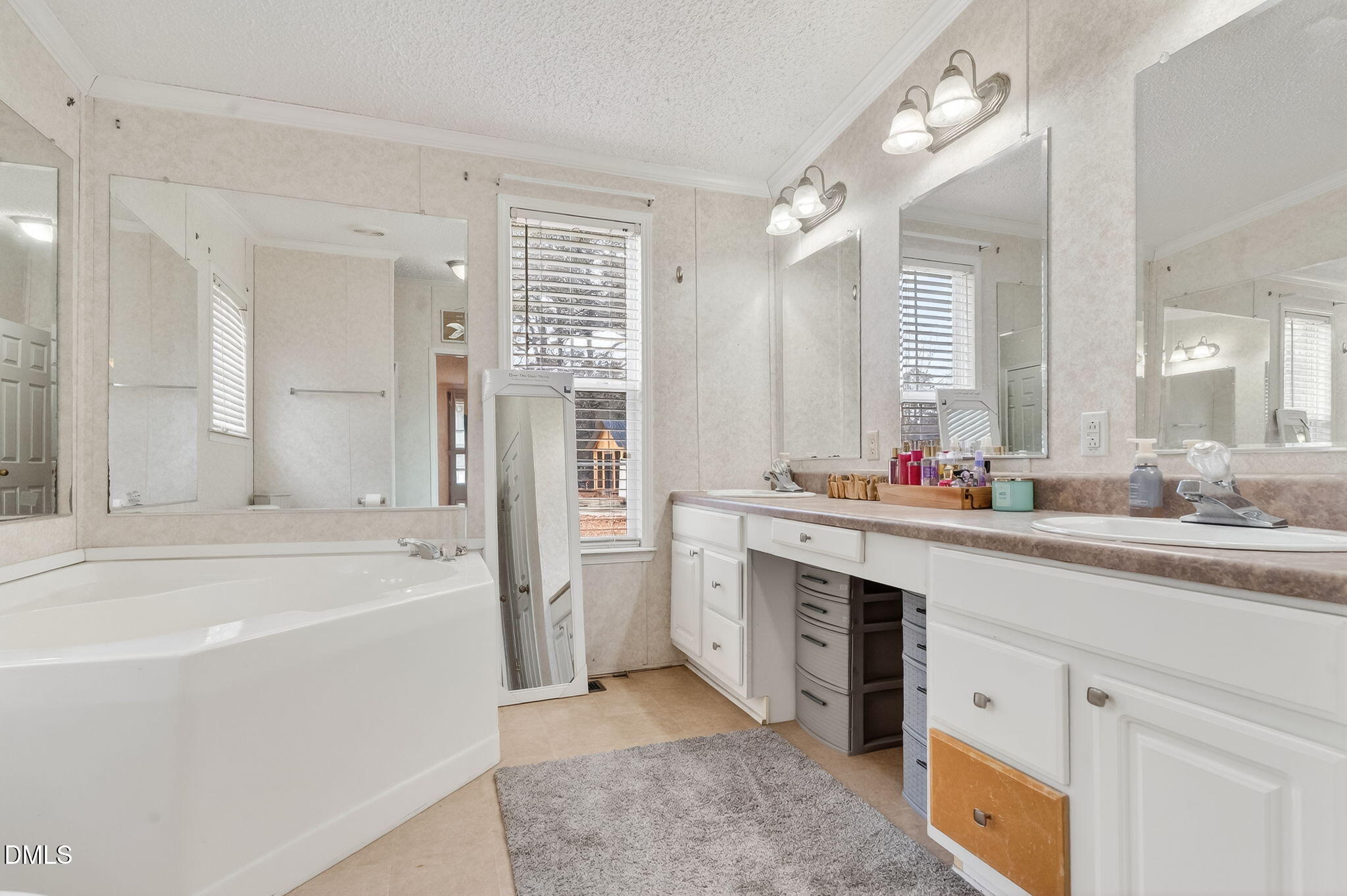 112 Morgan Street Erwin, NC 28339 - Photo 17 of 35 a spacious bathroom with a tub sink shower and mirror