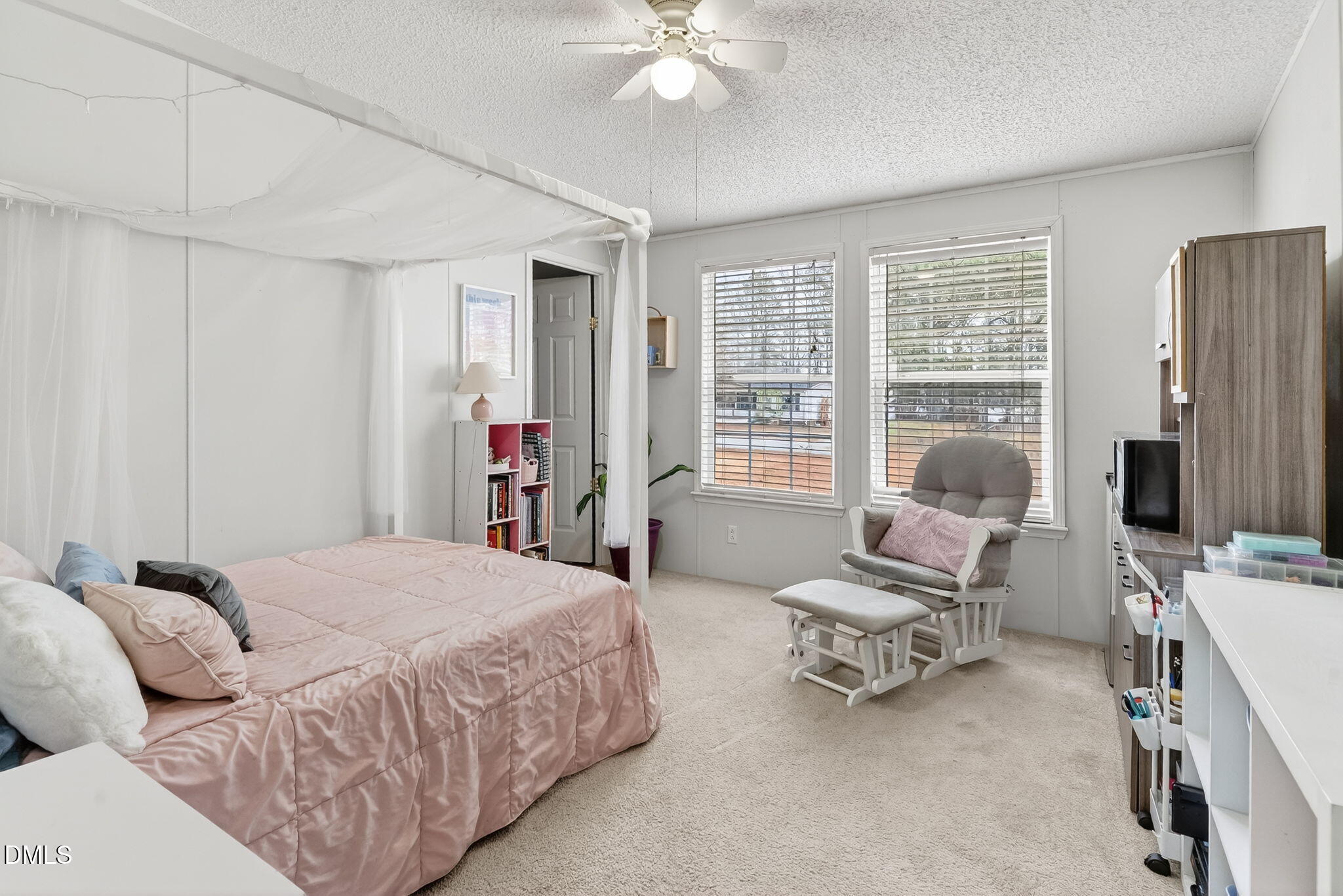 112 Morgan Street Erwin, NC 28339 - Photo 23 of 35 a bedroom with a bed a couch and a chandelier