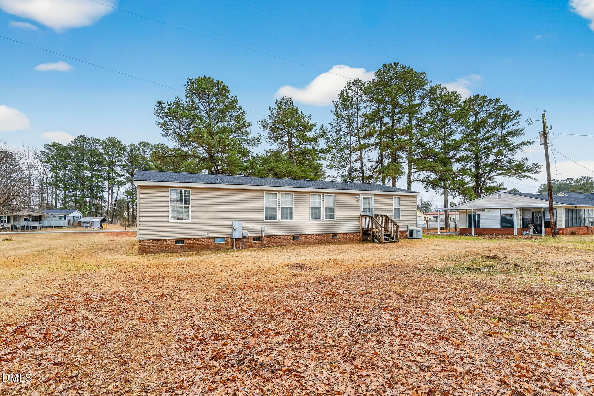 112 Morgan Street Erwin, NC 28339 - Photo 28 of 35 a front view of house with yard and trees in the background