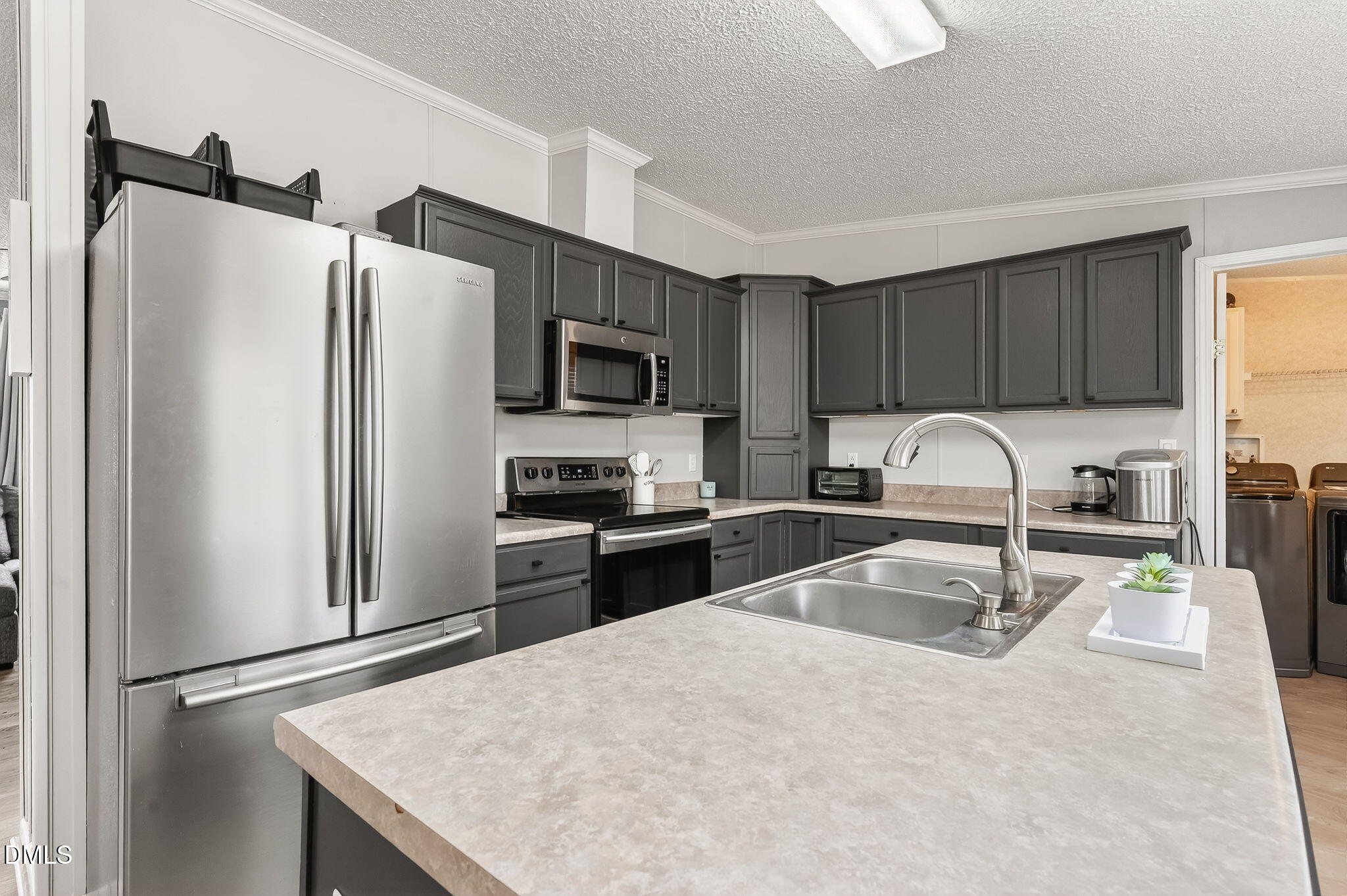 112 Morgan Street Erwin, NC 28339 - Photo 10 of 35 a kitchen with granite countertop a refrigerator and a sink