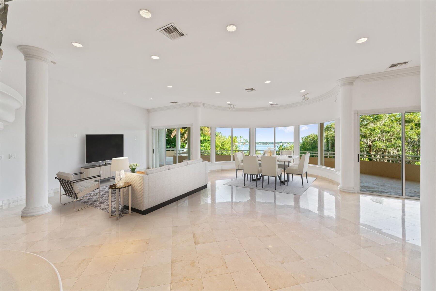 49 West High Point Road Sewall's Point, FL 34996 - Photo 15 of 99 a living room with furniture and a flat screen tv