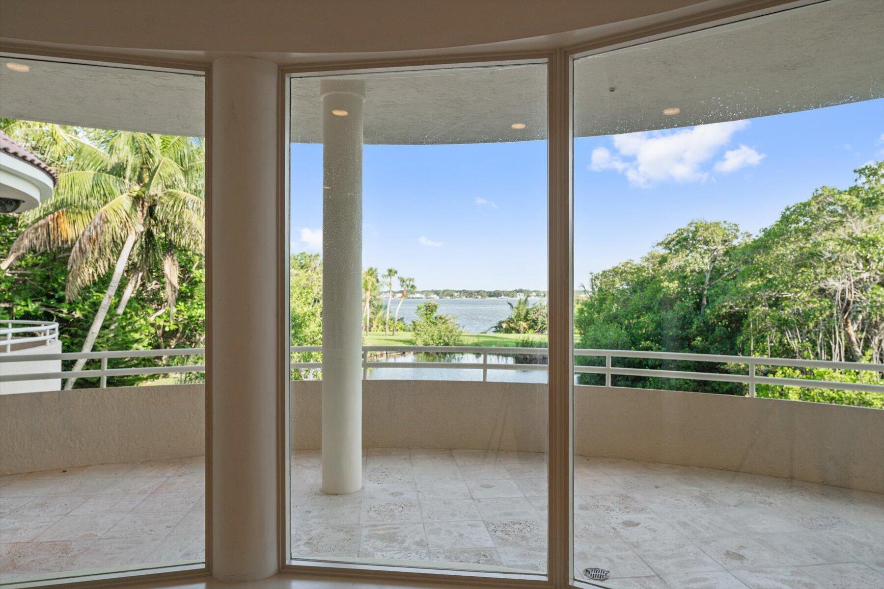 49 West High Point Road Sewall's Point, FL 34996 - Photo 24 of 99 a view of a floor to ceiling window and a tree in a room