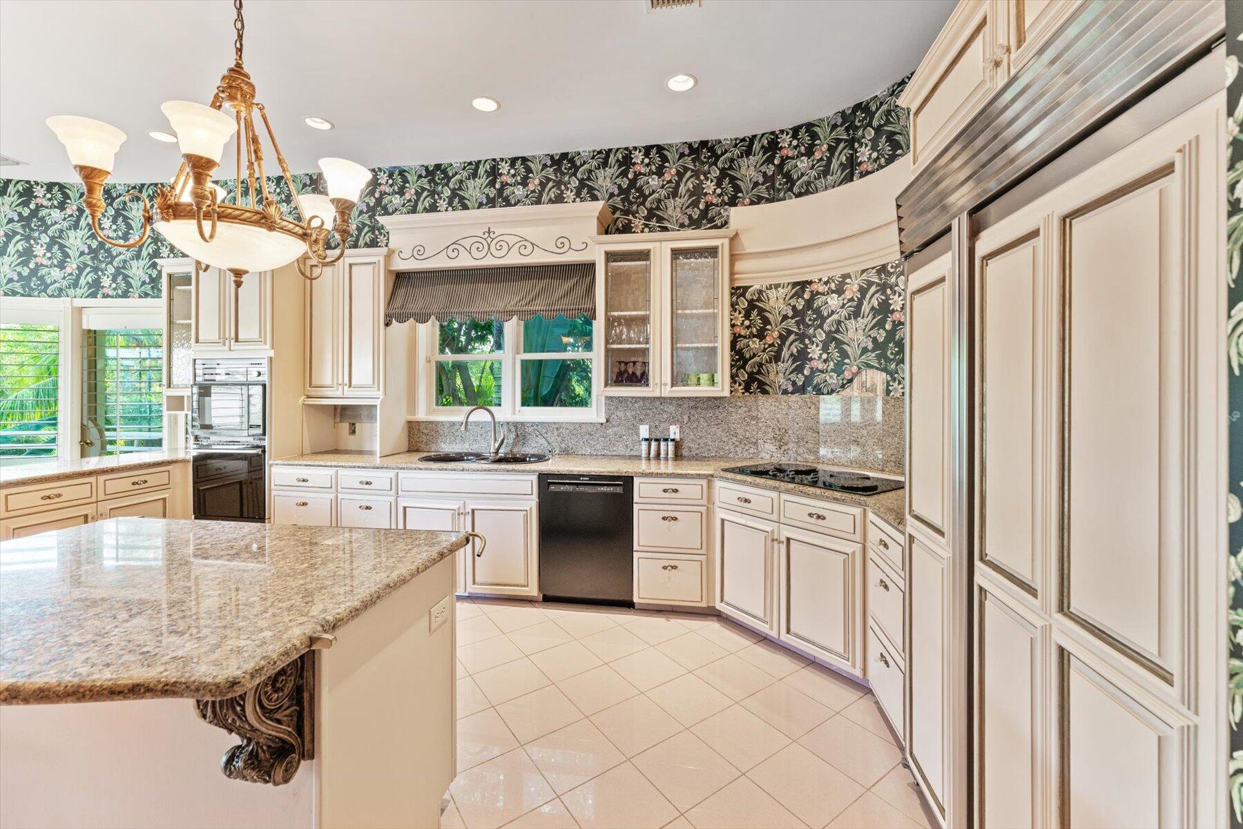49 West High Point Road Sewall's Point, FL 34996 - Photo 27 of 99 a kitchen with stainless steel appliances granite countertop a stove a sink and a refrigerator