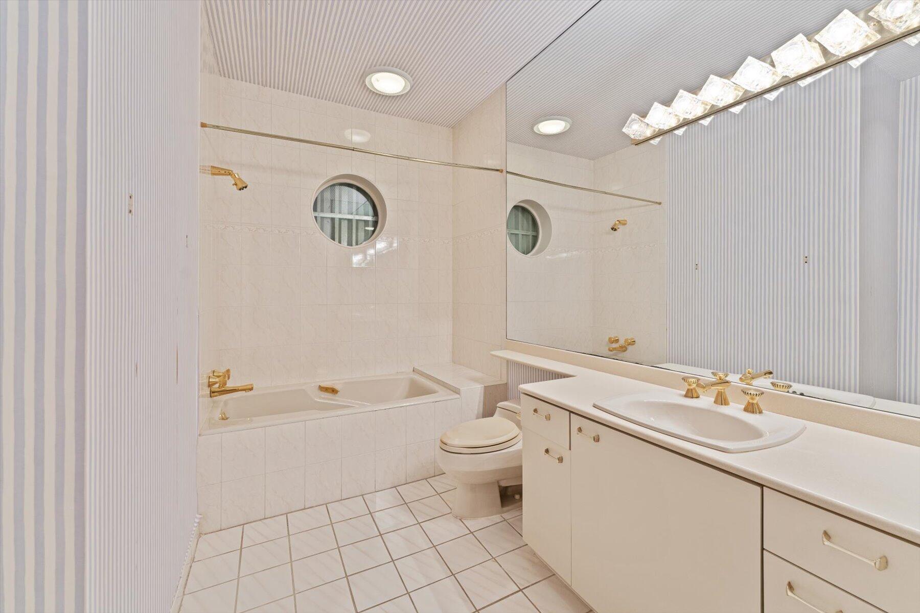 49 West High Point Road Sewall's Point, FL 34996 - Photo 48 of 99 a bathroom with a sink a toilet and shower